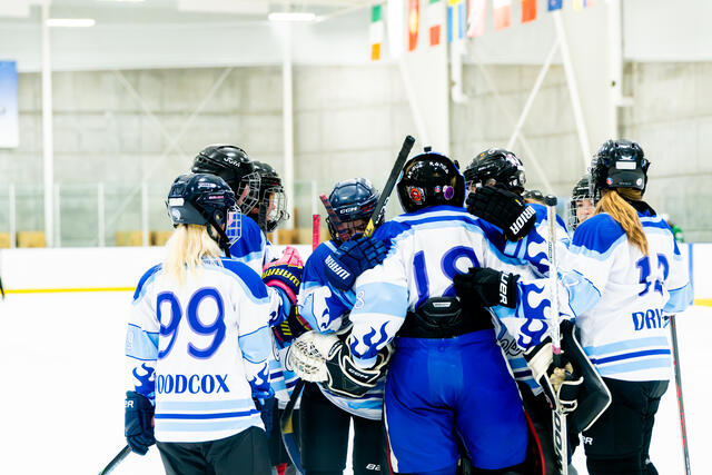 Coyotes huddle around the goalie